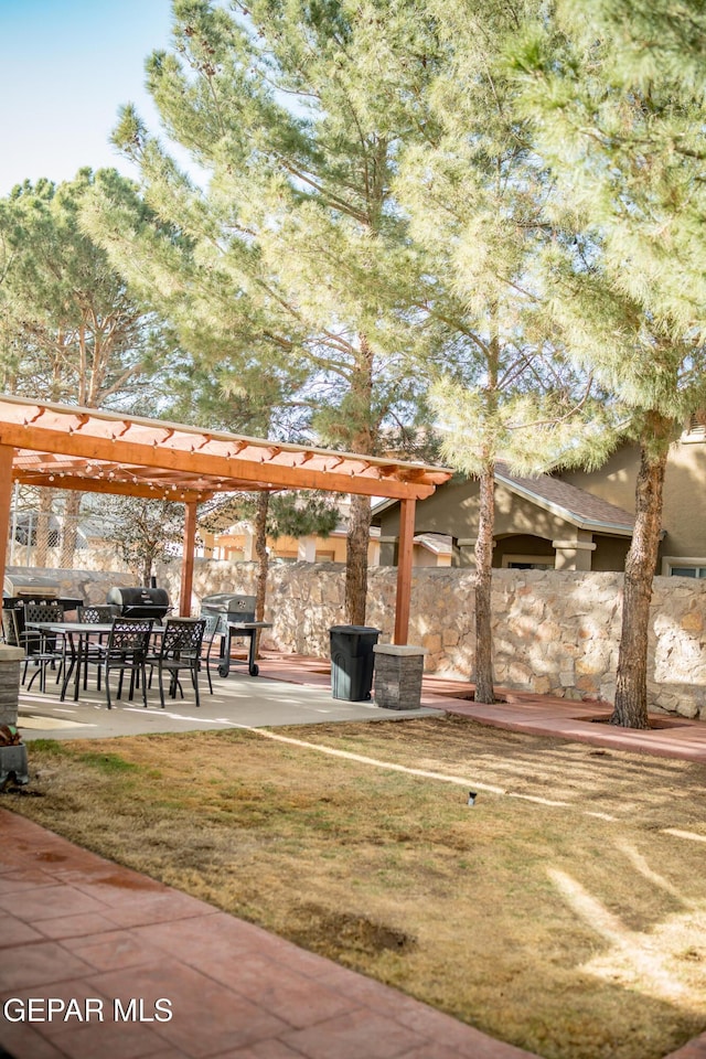 view of yard with a patio area, fence, and a pergola