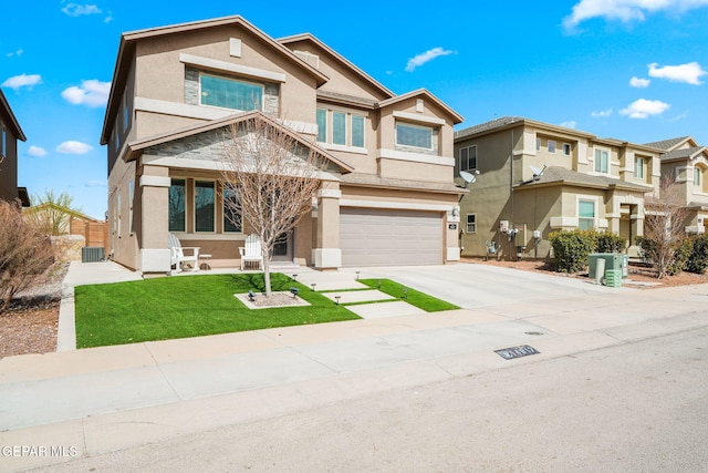 view of front of house with a front yard, concrete driveway, an attached garage, and stucco siding