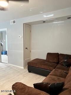 living room with light tile patterned floors and visible vents