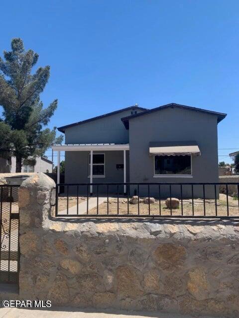 back of property featuring a fenced front yard