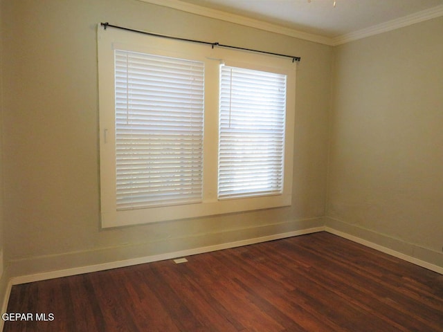 unfurnished room featuring baseboards, ornamental molding, and dark wood-style flooring