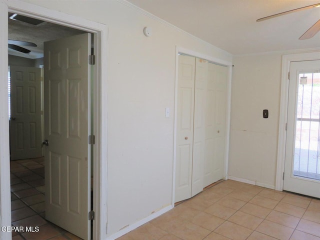 interior space with ornamental molding, baseboards, and light tile patterned floors