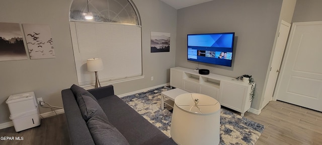 living room featuring baseboards and light wood finished floors