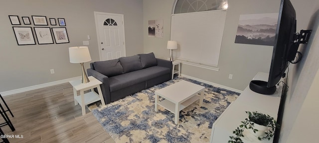 living room with light wood-style floors and baseboards