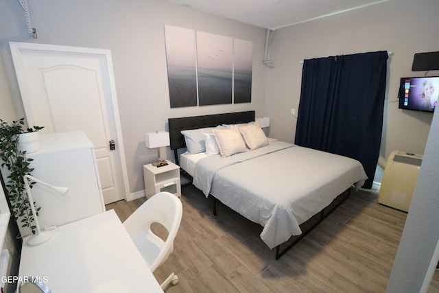 bedroom featuring wood finished floors