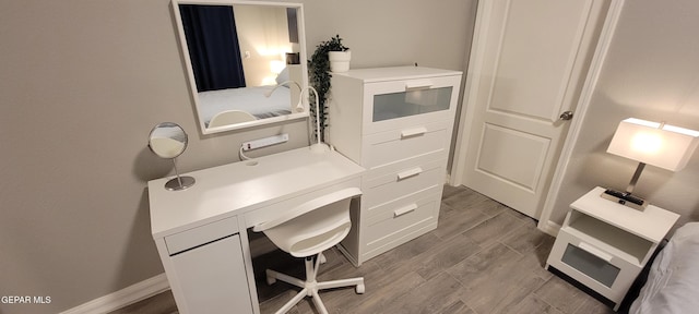 home office with wood tiled floor and baseboards