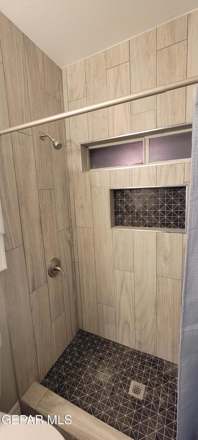 bathroom with a shower stall