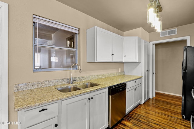 kitchen with visible vents, white cabinets, freestanding refrigerator, stainless steel dishwasher, and a sink