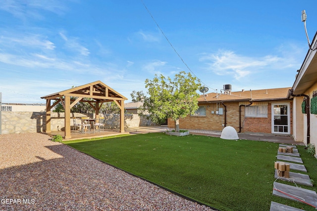 view of yard featuring fence, a gazebo, and a patio