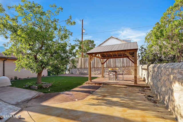 view of yard with a patio area, a fenced backyard, and a gazebo