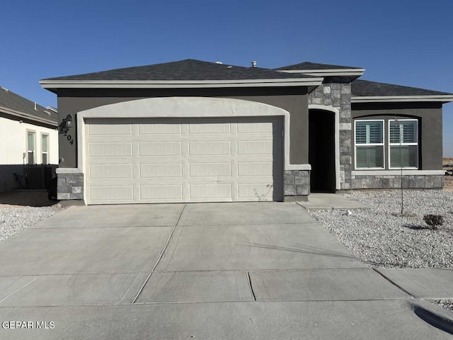 single story home featuring an attached garage, stone siding, concrete driveway, and stucco siding