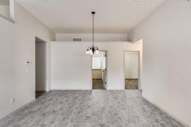 unfurnished dining area featuring baseboards, visible vents, and a chandelier