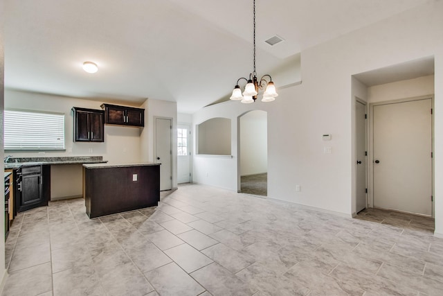 kitchen with dark brown cabinetry, a notable chandelier, visible vents, open floor plan, and pendant lighting