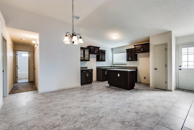 kitchen featuring a chandelier, light countertops, dark brown cabinets, a center island, and pendant lighting