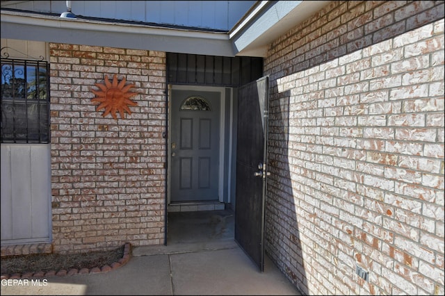 entrance to property with brick siding