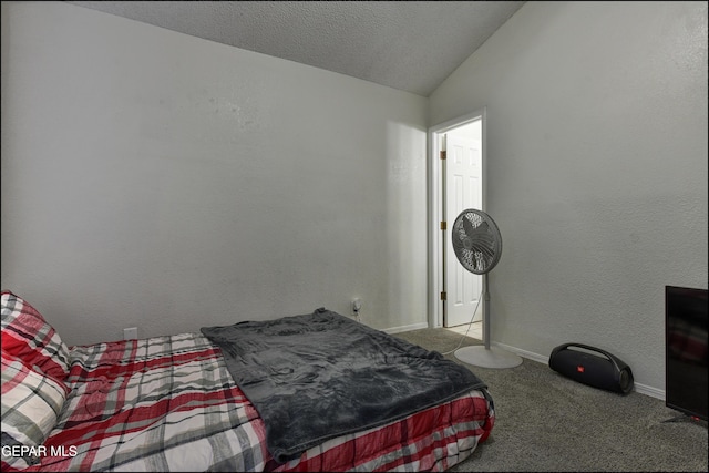 bedroom featuring lofted ceiling, a textured wall, light carpet, a textured ceiling, and baseboards