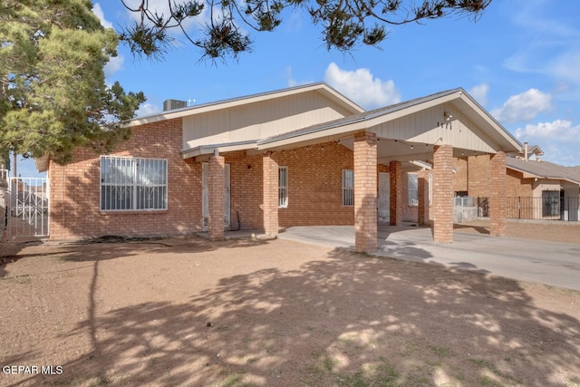 view of front of home featuring concrete driveway and brick siding