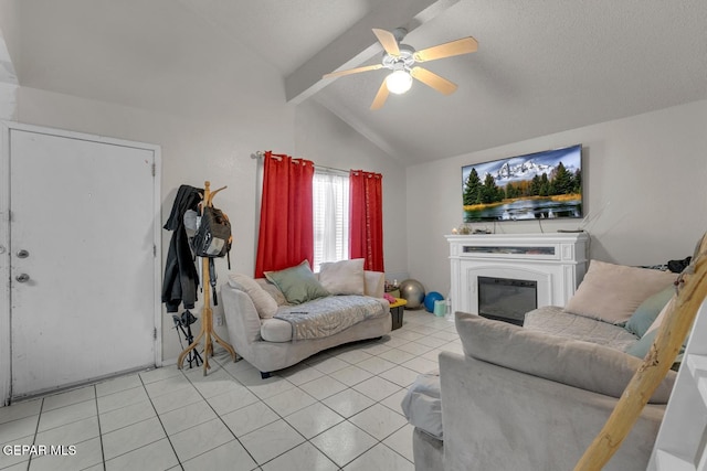 living area featuring vaulted ceiling with beams, light tile patterned flooring, a ceiling fan, and a glass covered fireplace