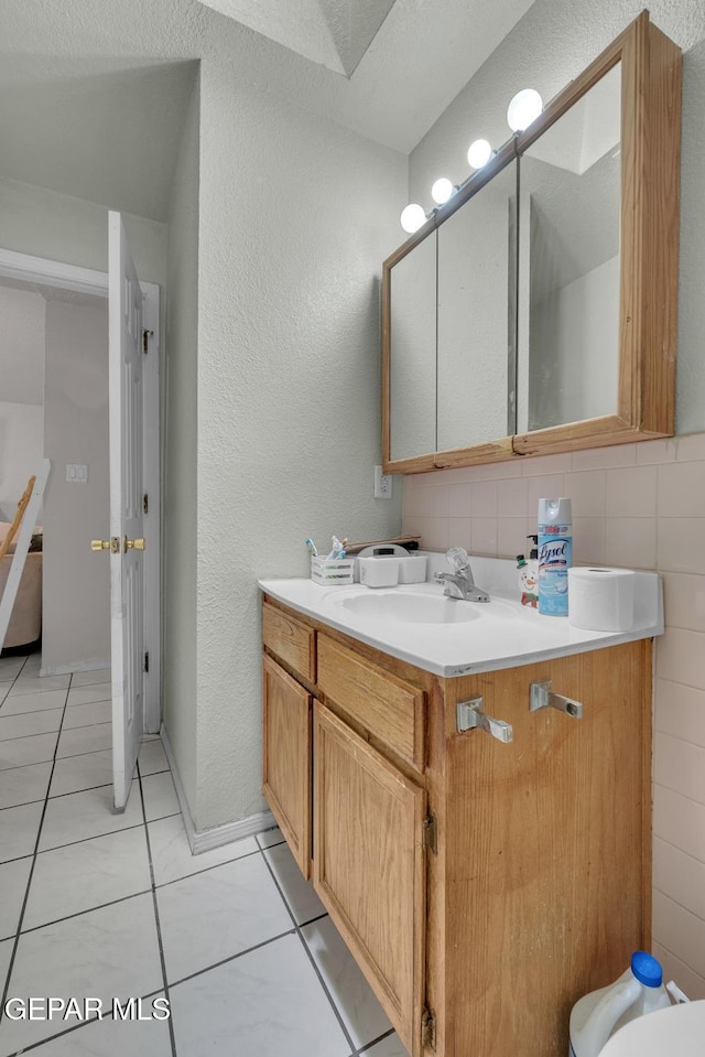 half bathroom with vanity and tile patterned floors