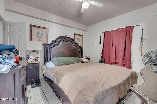 bedroom featuring light tile patterned floors, a ceiling fan, and a textured ceiling