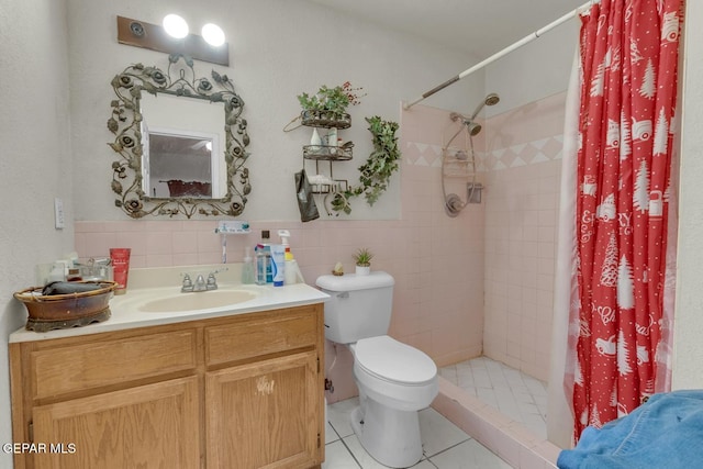 full bathroom featuring a stall shower, toilet, tile patterned floors, vanity, and tile walls