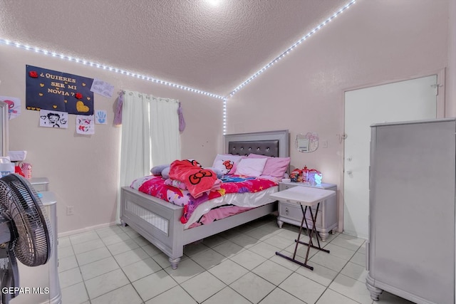 bedroom featuring vaulted ceiling, a textured ceiling, and light tile patterned flooring