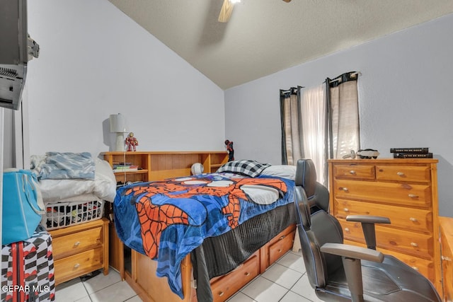 bedroom featuring ceiling fan, vaulted ceiling, a textured ceiling, and light tile patterned floors