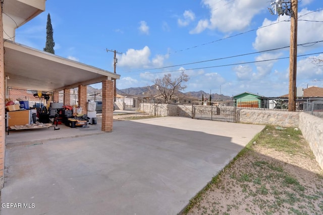 view of patio / terrace with fence and a mountain view