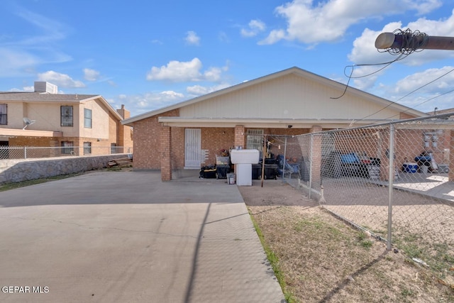 back of property with fence and brick siding