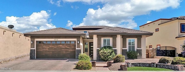 view of front facade with an attached garage, a tile roof, decorative driveway, and stucco siding