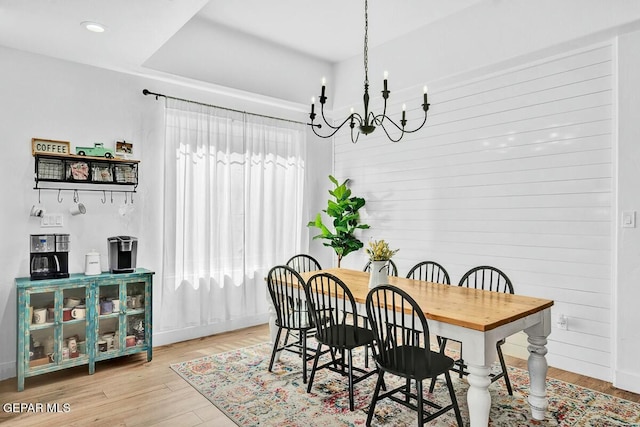 dining area with recessed lighting, an inviting chandelier, and wood finished floors