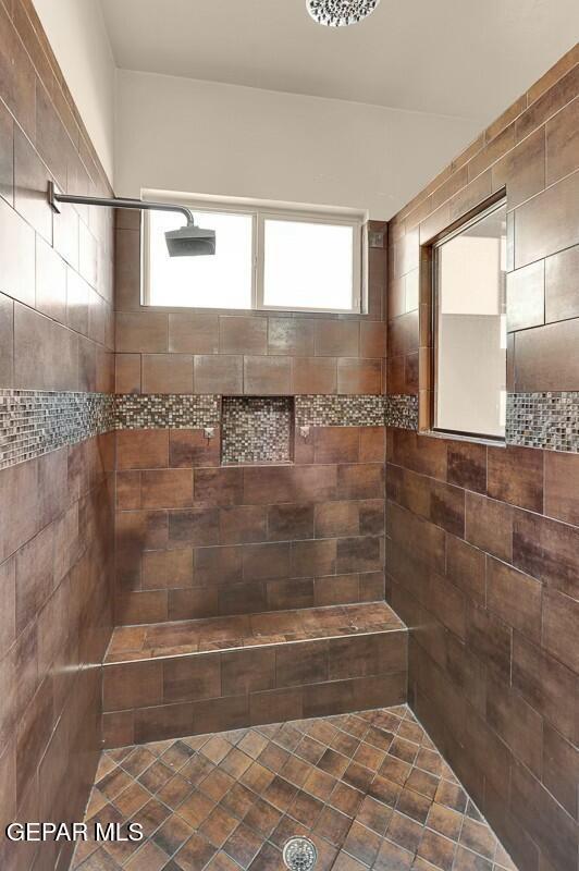 bathroom with tiled shower