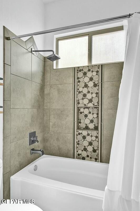 full bathroom featuring shower / tub combo with curtain