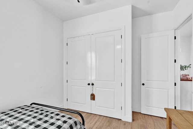 bedroom featuring a closet and light wood-style flooring