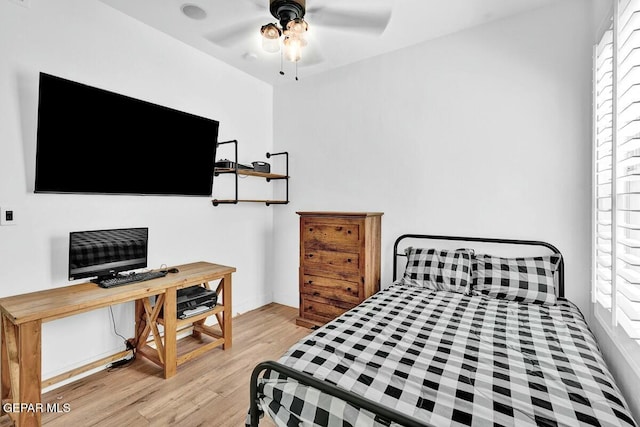 bedroom featuring wood finished floors and a ceiling fan