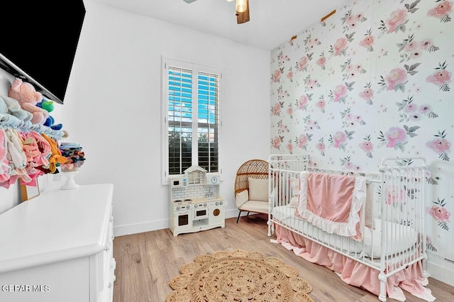 bedroom with light wood-style floors, baseboards, and a ceiling fan