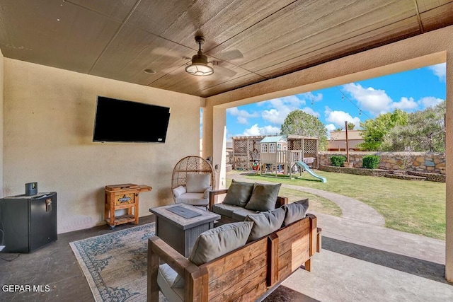 view of patio with outdoor lounge area, a playground, and fence