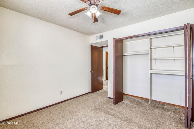 unfurnished bedroom with light carpet, a textured ceiling, visible vents, and baseboards