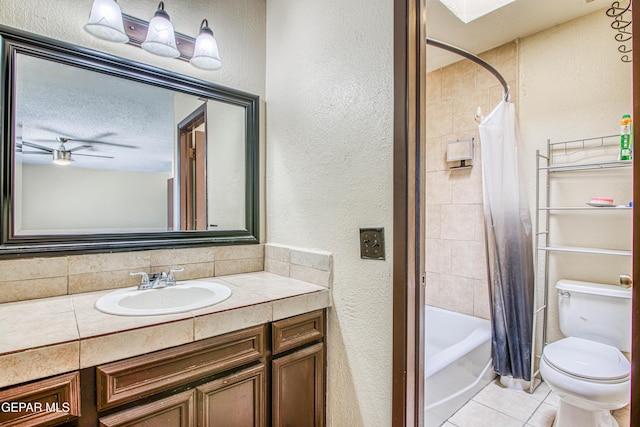 bathroom featuring ceiling fan, tile patterned flooring, toilet, vanity, and shower / bathtub combination with curtain