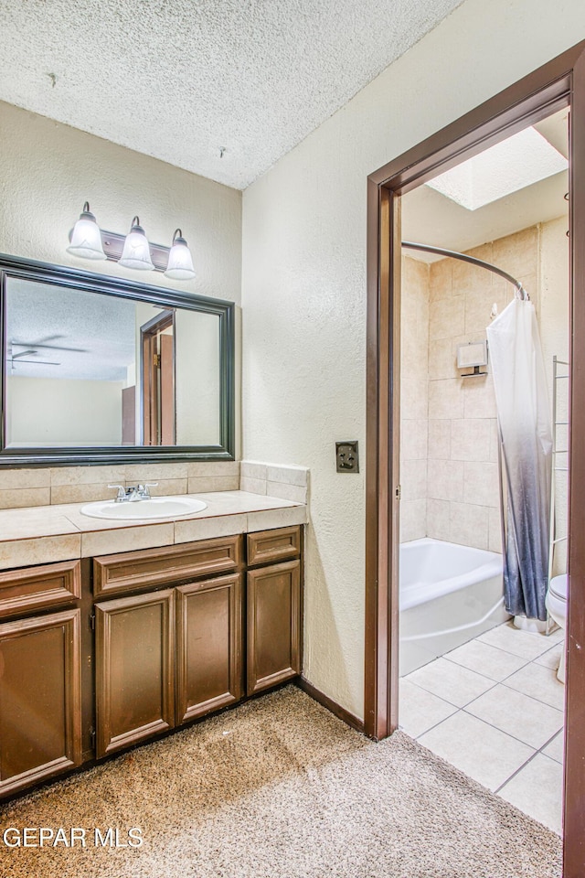 bathroom featuring shower / tub combo, a textured wall, toilet, a textured ceiling, and vanity