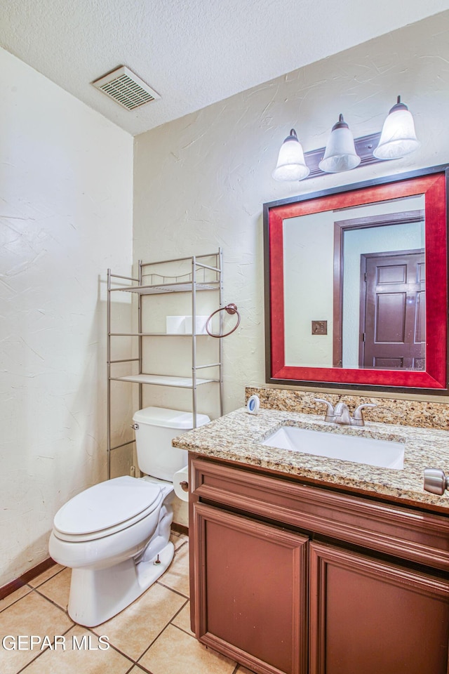 half bath featuring visible vents, toilet, tile patterned floors, a textured ceiling, and vanity