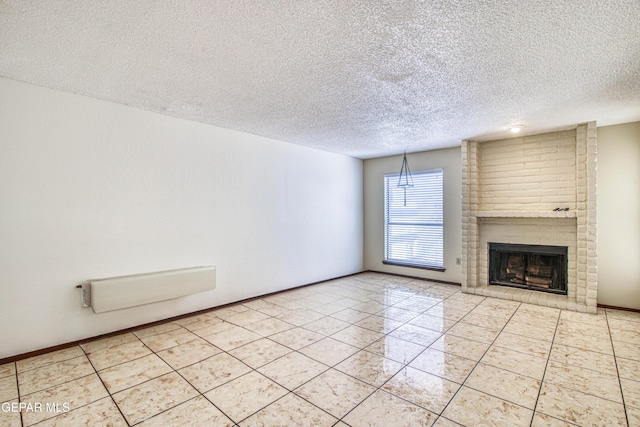 unfurnished living room featuring light tile patterned flooring, a fireplace, a textured ceiling, and baseboards