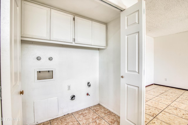 clothes washing area featuring hookup for a washing machine, light tile patterned floors, cabinet space, gas dryer hookup, and baseboards