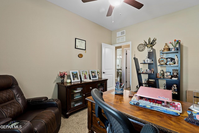 office space featuring light colored carpet, ceiling fan, and visible vents