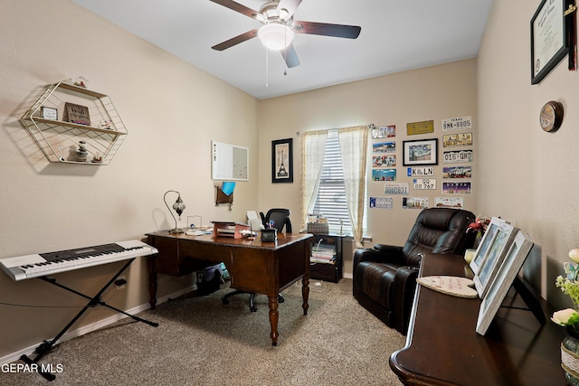 home office featuring light carpet, baseboards, and a ceiling fan