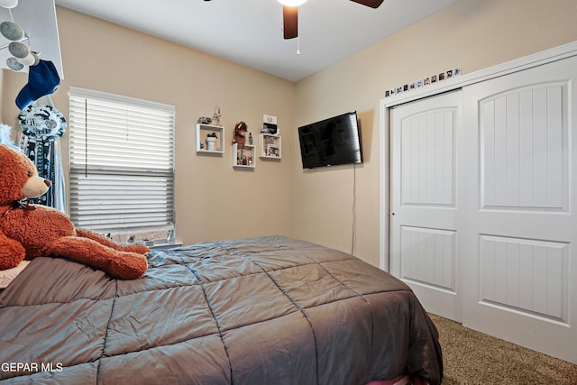 carpeted bedroom featuring a closet and a ceiling fan