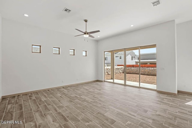 unfurnished room with light wood finished floors, visible vents, a ceiling fan, and recessed lighting