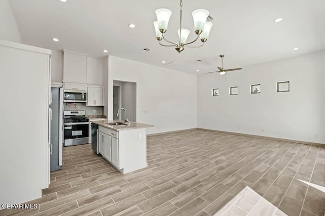 kitchen featuring an island with sink, appliances with stainless steel finishes, white cabinetry, pendant lighting, and a sink