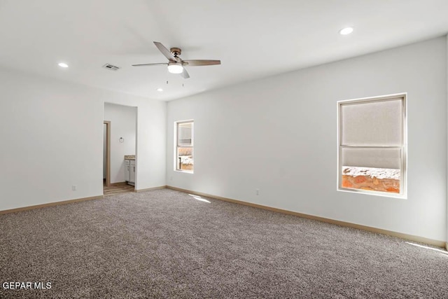 unfurnished room featuring ceiling fan, recessed lighting, visible vents, baseboards, and carpet