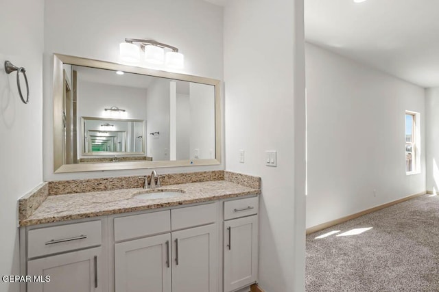 bathroom with vanity and baseboards